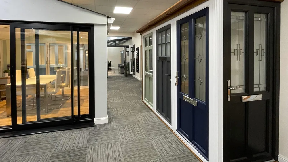 Showroom display of composite doors and black bi-fold doors