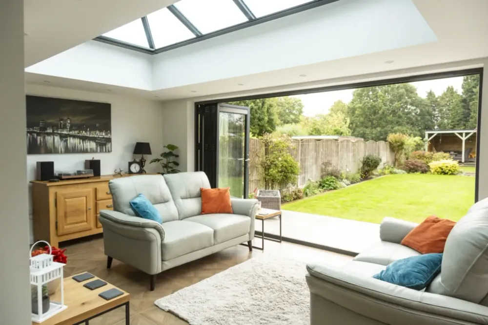 Light-filled kitchen extension with roof lantern and open bi-fold doors